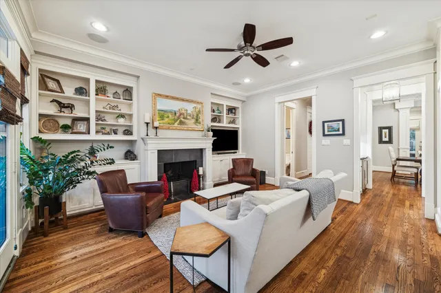 a living room with furniture fireplace and a large window