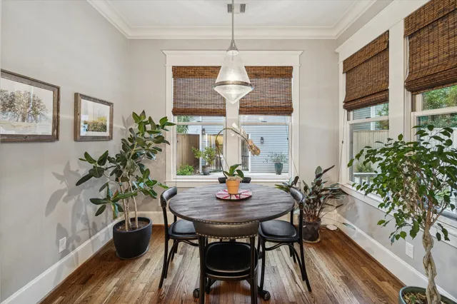 a view of a dining room with furniture window and wooden floor