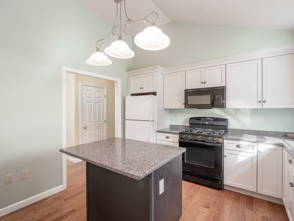 83 Cherry Street Taunton, MA 02780 - Photo 21 of 42 a kitchen with stainless steel appliances granite countertop a stove top oven a sink dishwasher and a refrigerator with wooden floor