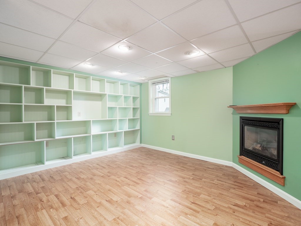 83 Cherry Street Taunton, MA 02780 - Photo 25 of 42 a view of an empty room with a fireplace and a window