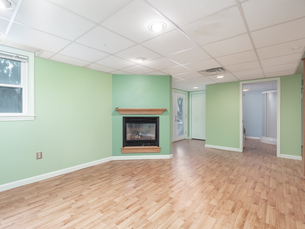 83 Cherry Street Taunton, MA 02780 - Photo 26 of 42 a view of an empty room with a fireplace and a window