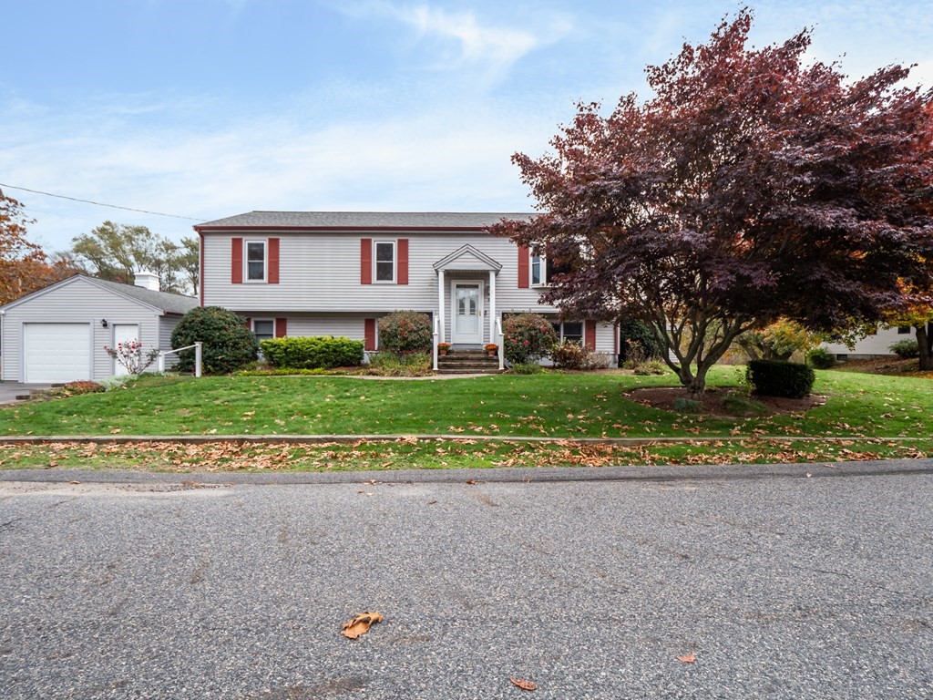83 Cherry Street Taunton, MA 02780 - Photo 39 of 42 a front view of a house with a yard and road