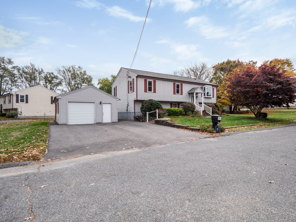 83 Cherry Street Taunton, MA 02780 - Photo 40 of 42 a front view of a house with a yard and garage