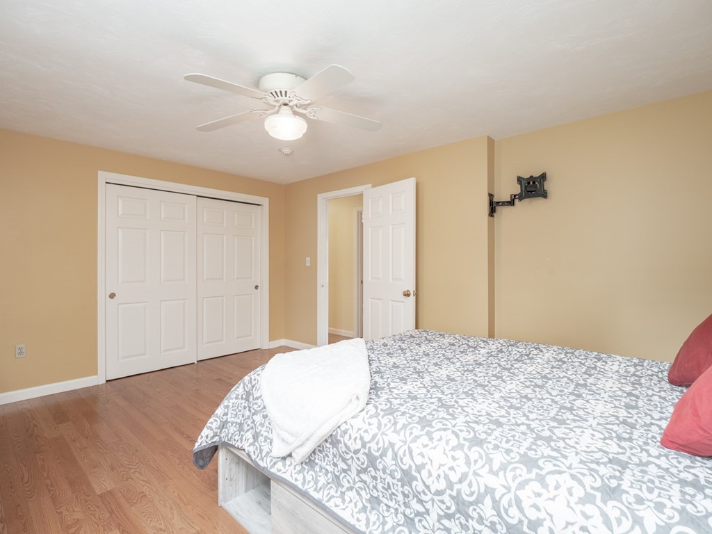 83 Cherry Street Taunton, MA 02780 - Photo 9 of 42 a bedroom with a bed and a chandelier