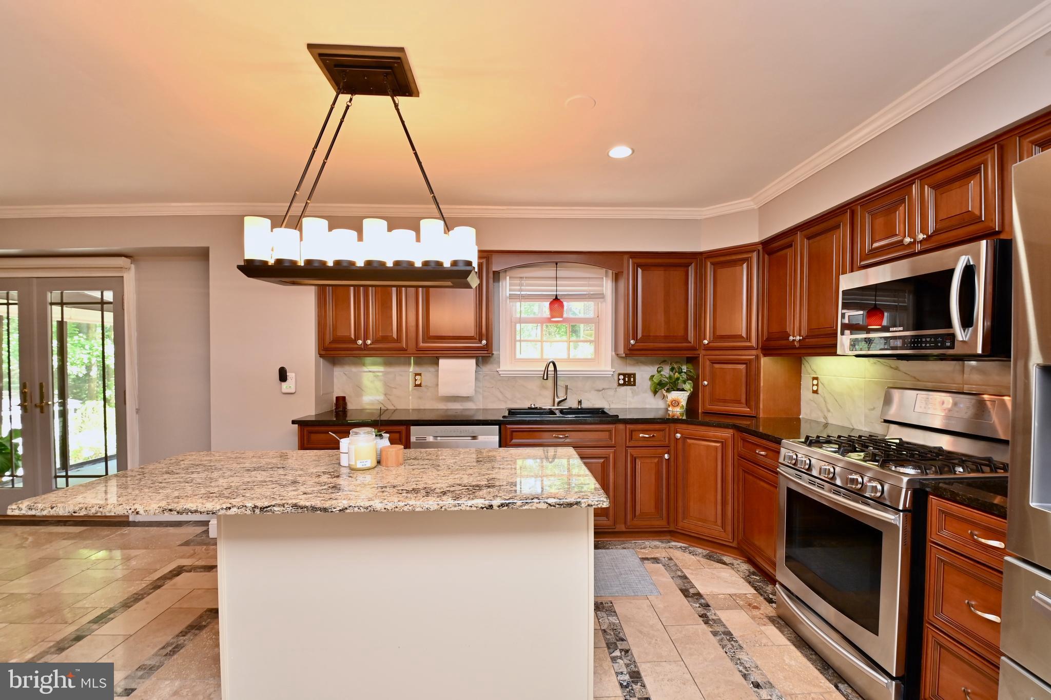 4319 Old Mill Road Alexandria, VA 22309 - Photo 41 of 86 a kitchen with kitchen island granite countertop a sink stove and cabinets
