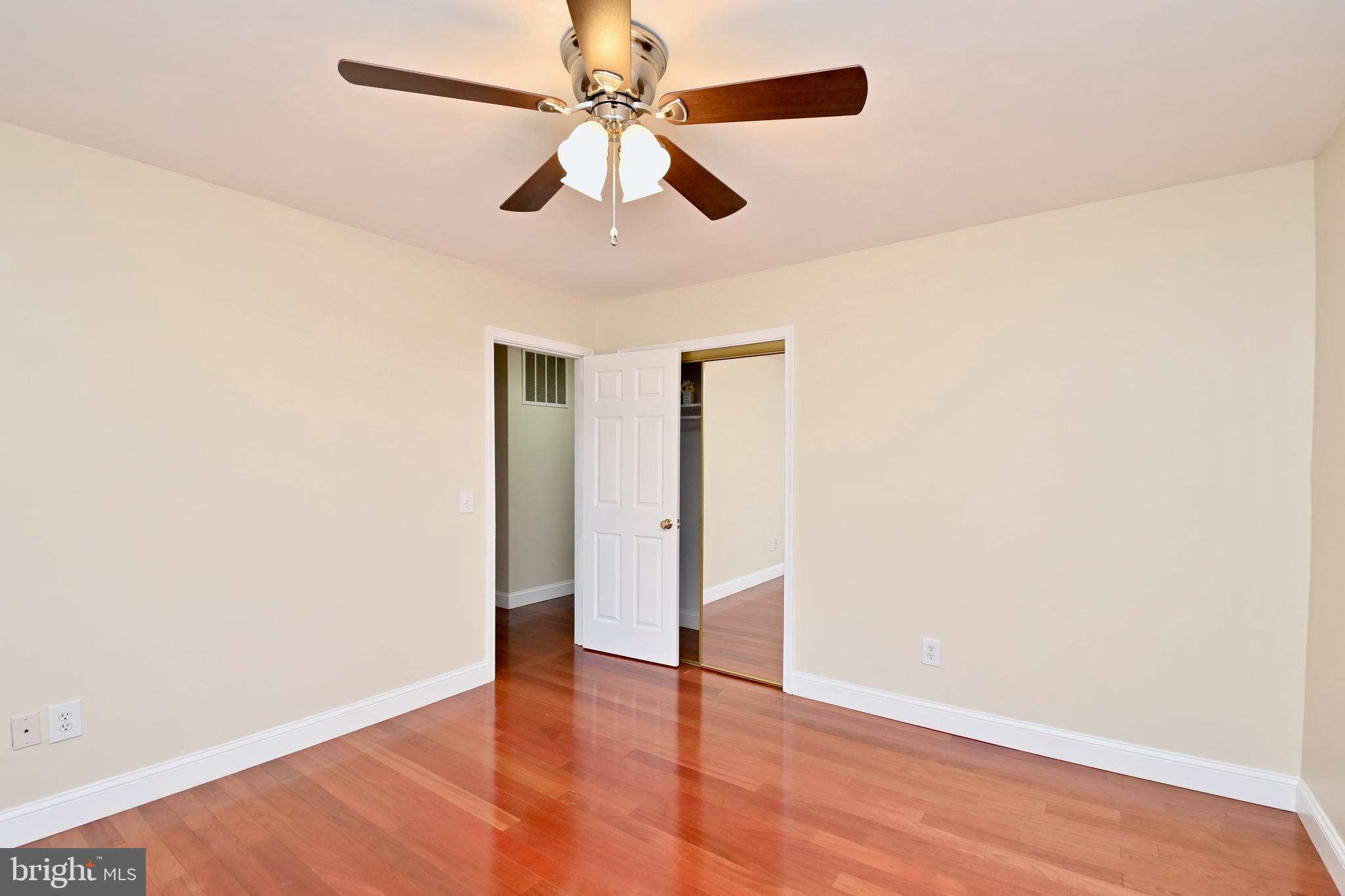 4319 Old Mill Road Alexandria, VA 22309 - Photo 48 of 86 an empty room with wooden floor ceiling fan and windows