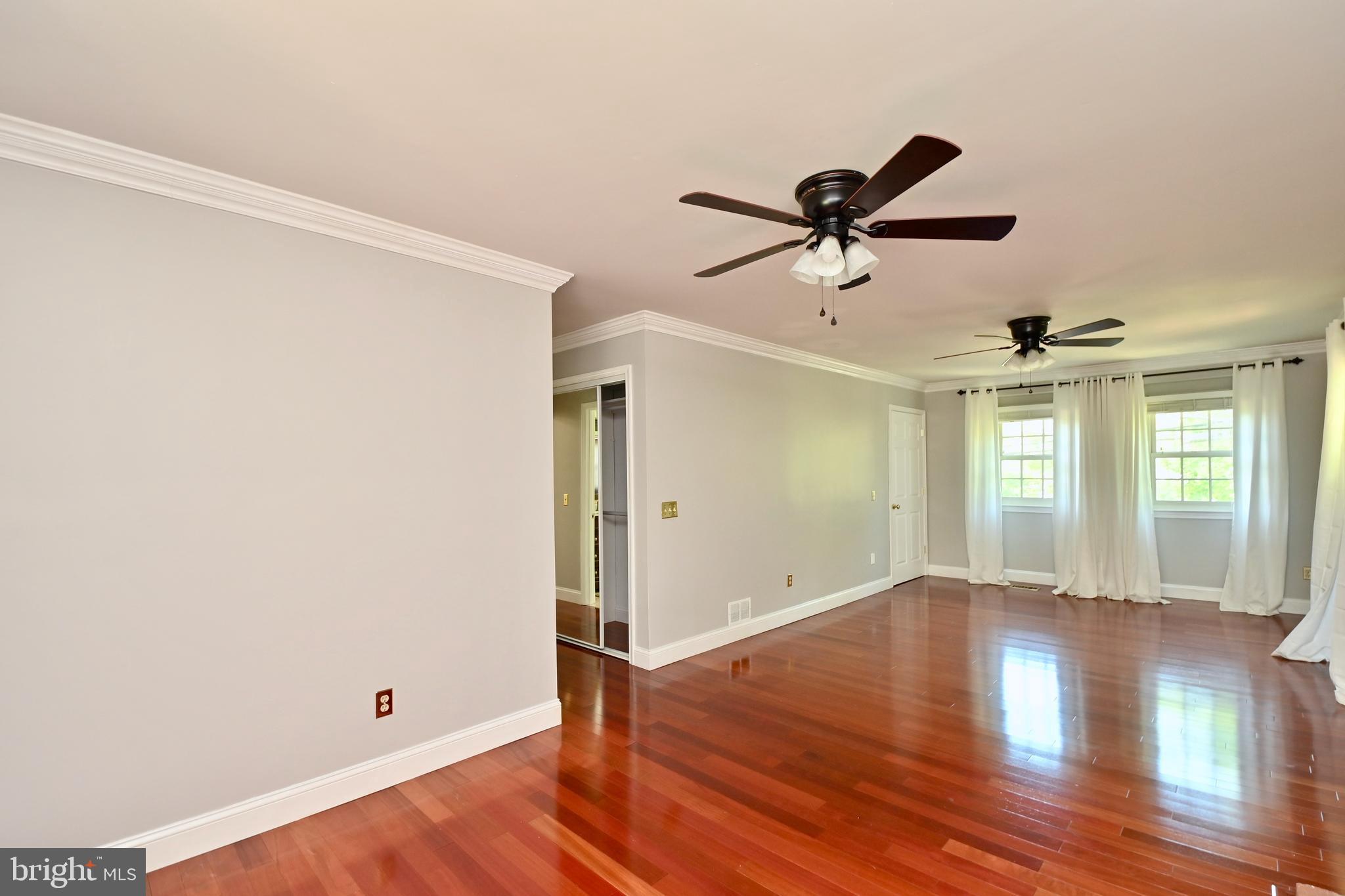 4319 Old Mill Road Alexandria, VA 22309 - Photo 57 of 86 a view of a room with wooden floor and a ceiling fan