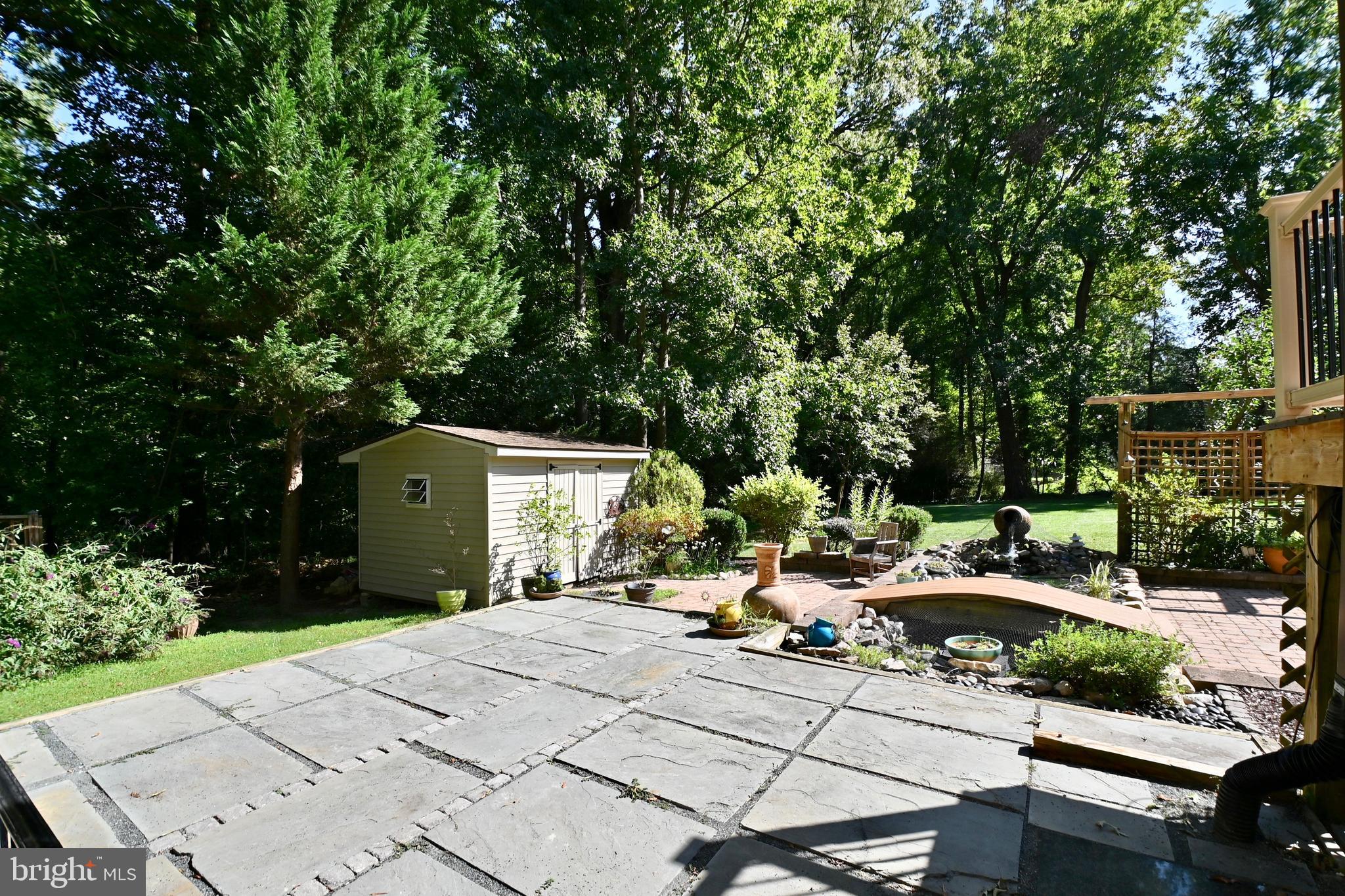 4319 Old Mill Road Alexandria, VA 22309 - Photo 70 of 86 a view of backyard with a table and chairs under an umbrella