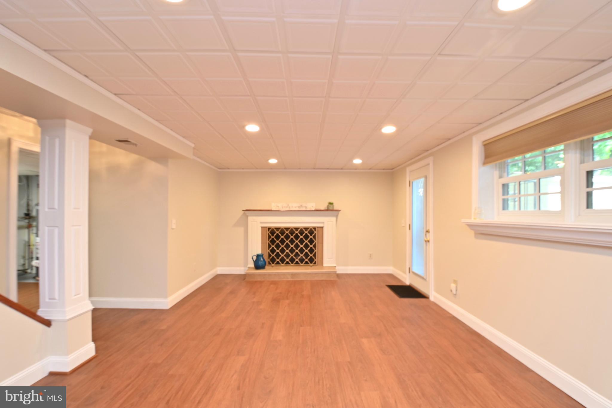 4319 Old Mill Road Alexandria, VA 22309 - Photo 7 of 86 a view of an empty room with wooden floor and a window