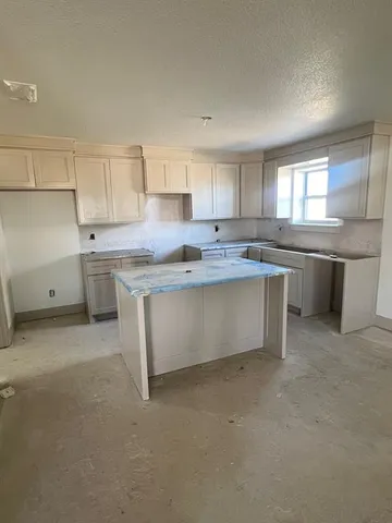 a view of empty room with a fireplace