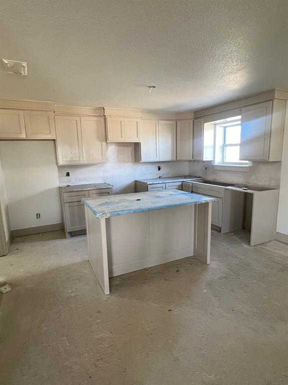 1390 Poe Prairie Road Millsap, TX 76066 - Photo 30 of 40 a large kitchen with stainless steel appliances granite countertop a stove a sink dishwasher and a refrigerator