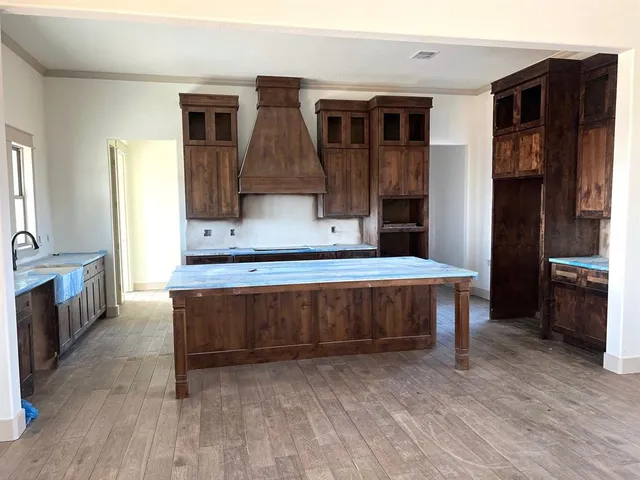 a living room with a table chairs and kitchen view