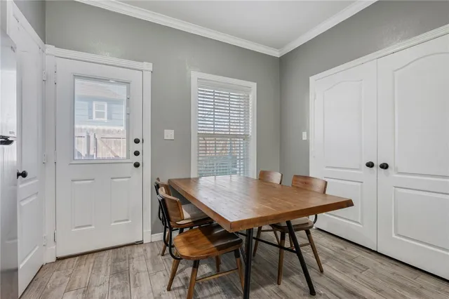 a view of a dining room with furniture and wooden floor