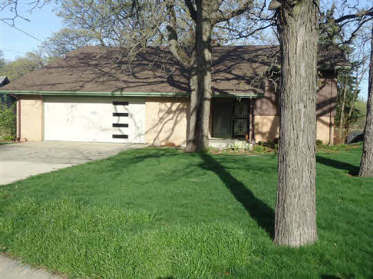 6304 Park Ridge Road Loves Park, IL 61111 - Photo 1 of 11 a view of a house with a backyard