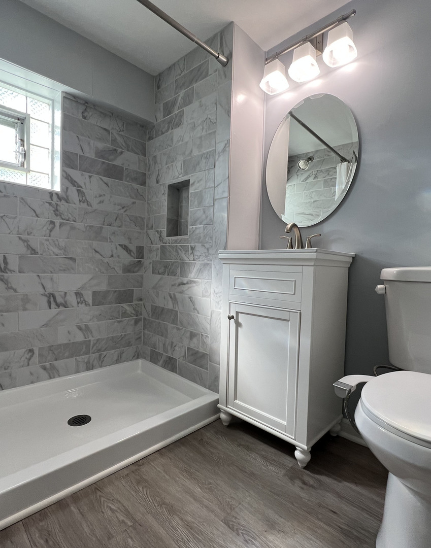 3N276 North Howard Avenue Elmhurst, IL 60126 - Photo 19 of 29 a bathroom with a sink a mirror a toilet and a mirror