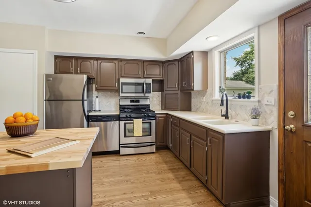 a kitchen with a sink appliances and cabinets