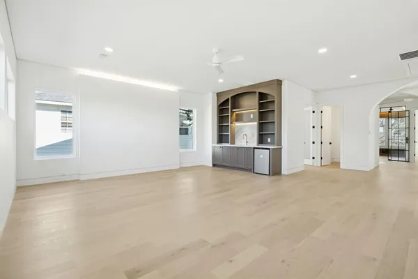 a view of an empty room with wooden shelves