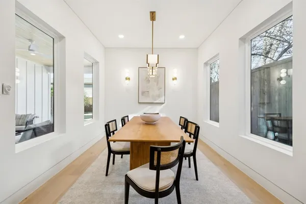 a dining room with stainless steel appliances kitchen island a table and chairs