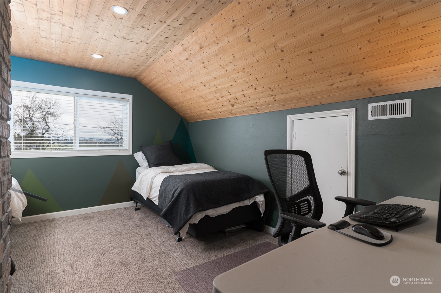 5757 Barr Road Ferndale, WA 98248 - Photo 21 of 40 a bedroom with a bed a mirror and a window