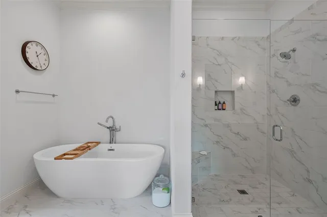 a bathroom with a bathtub and a shower