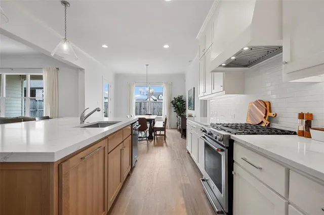a kitchen with sink stove and cabinets