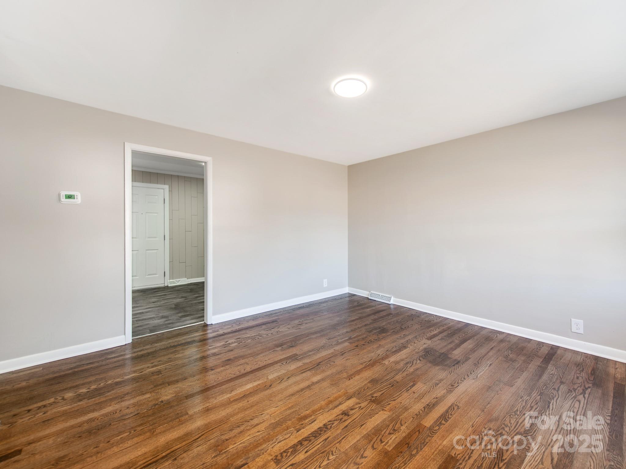 502 McConnell Street Clover, SC 29710 - Photo 4 of 25 a view of an empty room with wooden floor and closet
