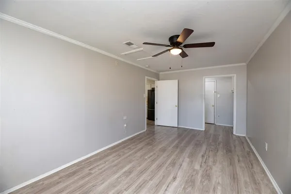 a view of an empty room and wooden floor