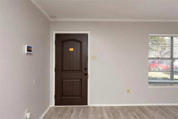 a view of a livingroom with wooden floor and window