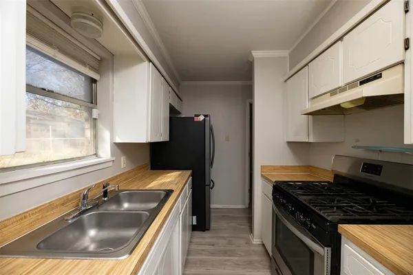 a kitchen that has a sink and a stove