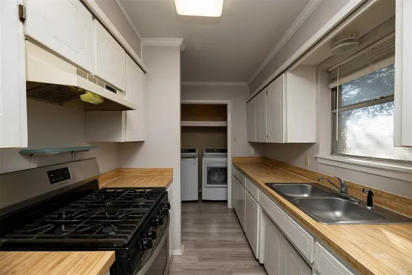 a kitchen with a stove a sink and a refrigerator