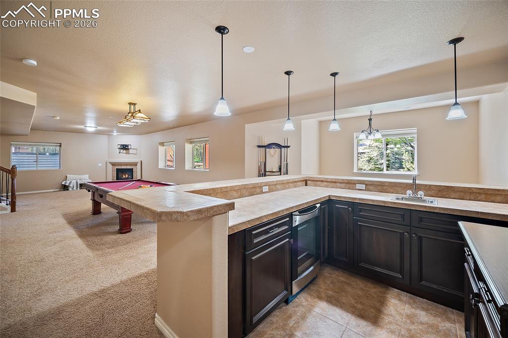 1117 Spectrum Loop Colorado Springs, CO 80921 - Photo 18 of 31 a kitchen with stainless steel appliances granite countertop a sink a stove and a wooden floors