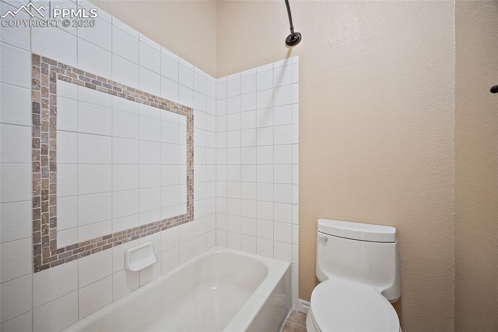 1117 Spectrum Loop Colorado Springs, CO 80921 - Photo 20 of 31 a white toilet sitting next to a bath tub