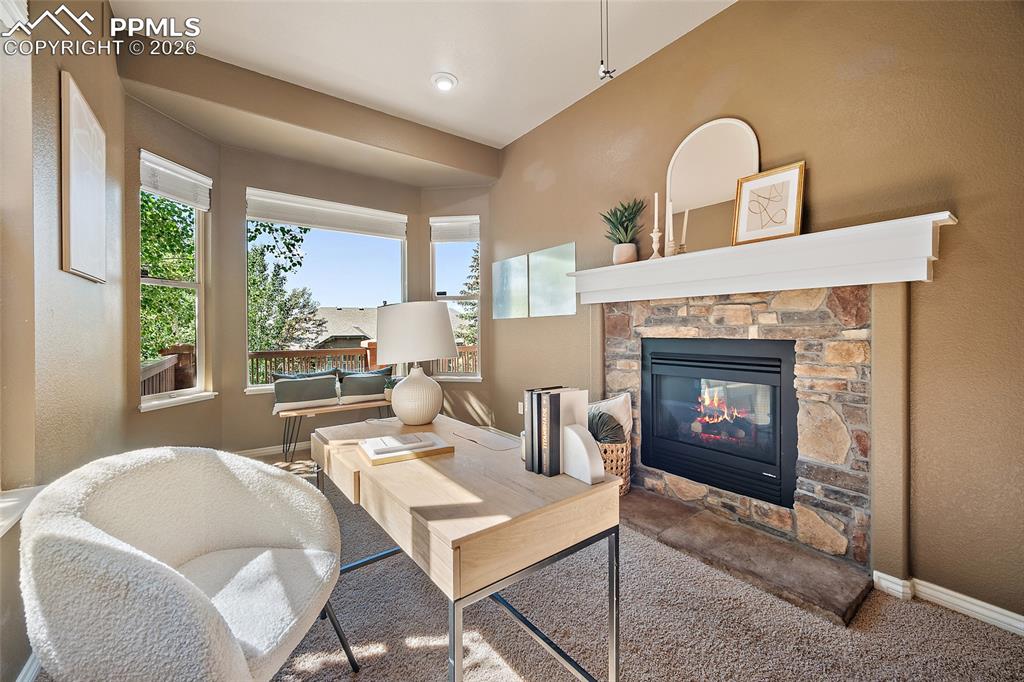 1117 Spectrum Loop Colorado Springs, CO 80921 - Photo 2 of 31 a living room with furniture and a fireplace