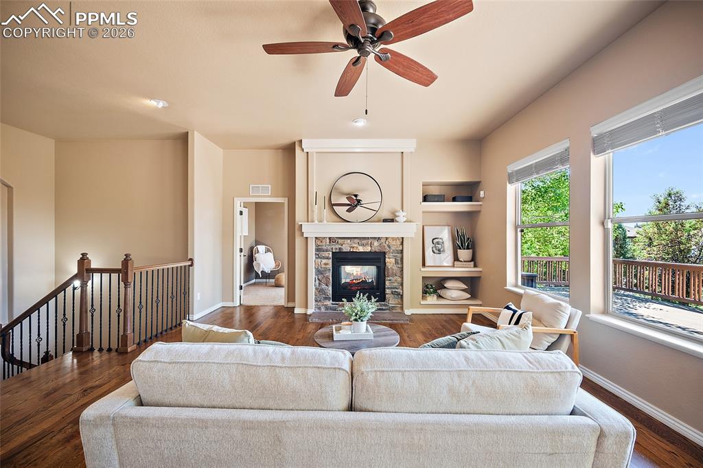 1117 Spectrum Loop Colorado Springs, CO 80921 - Photo 5 of 31 a living room with furniture a fireplace and a large window