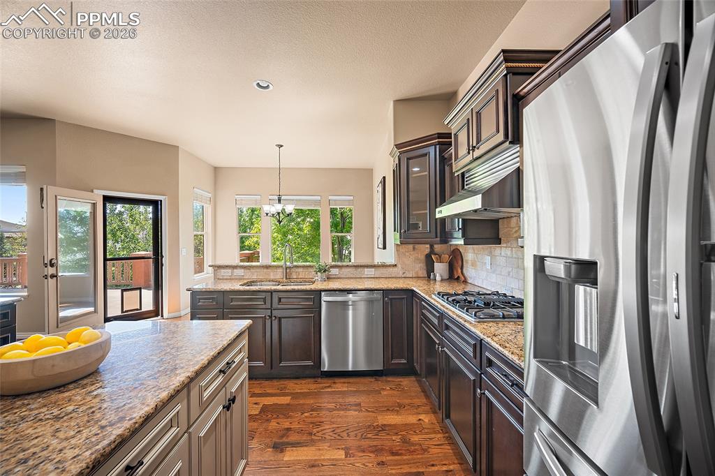 1117 Spectrum Loop Colorado Springs, CO 80921 - Photo 9 of 31 a kitchen with stainless steel appliances granite countertop a sink stove and refrigerator