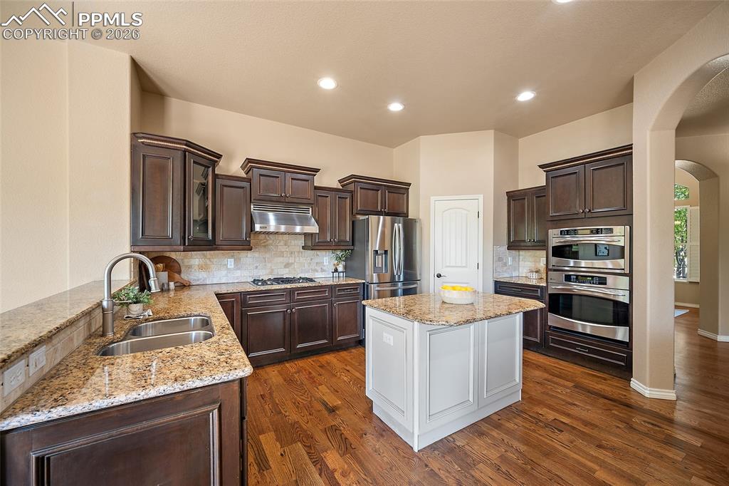 1117 Spectrum Loop Colorado Springs, CO 80921 - Photo 10 of 31 a kitchen with stainless steel appliances granite countertop a sink stove and refrigerator