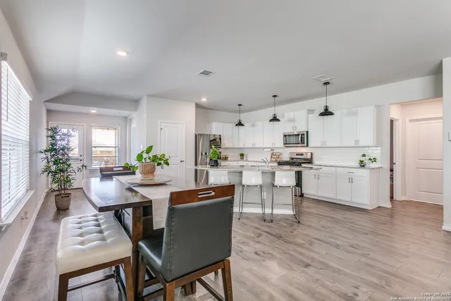 a view of kitchen with cabinets table and chairs