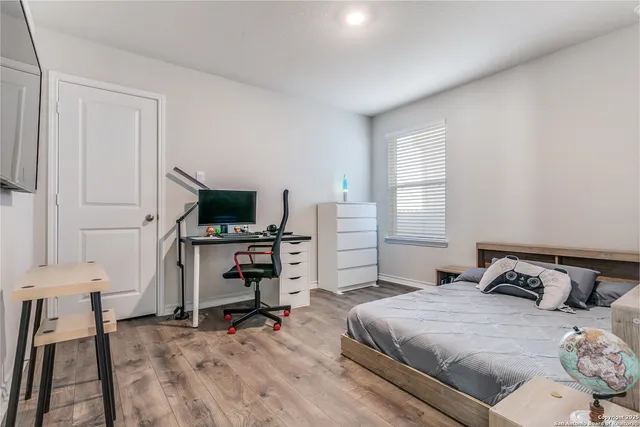 a bedroom with a bed and a flat screen tv