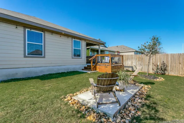 a backyard of a house with table and chairs