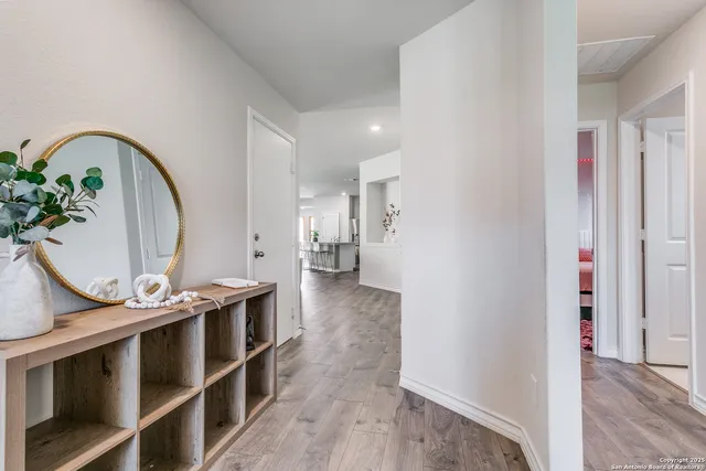 a view of living room with furniture and wooden floor