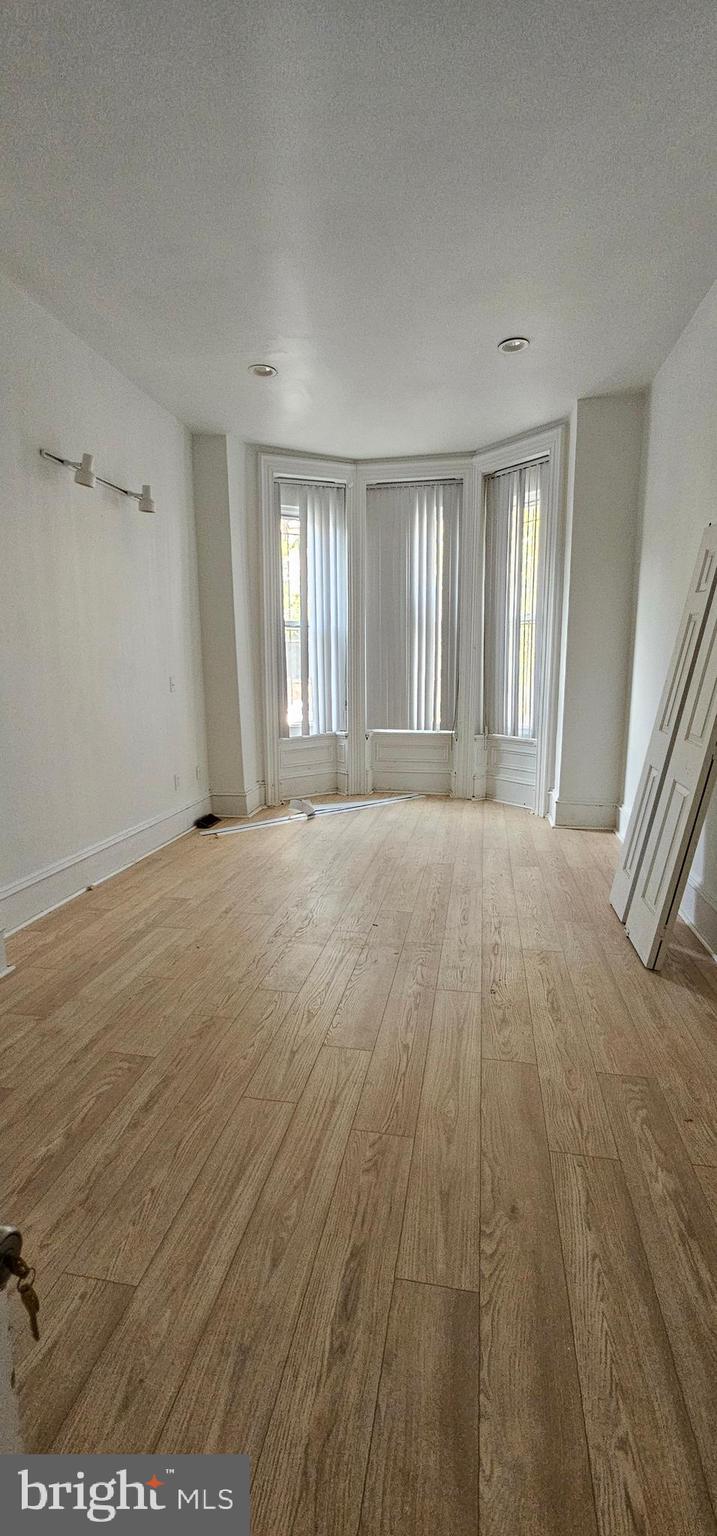3618 Spring Garden Street Philadelphia, PA 19104 - Photo 14 of 41 wooden floor in an empty room with a window