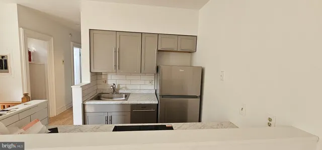 a kitchen with a sink stove and microwave
