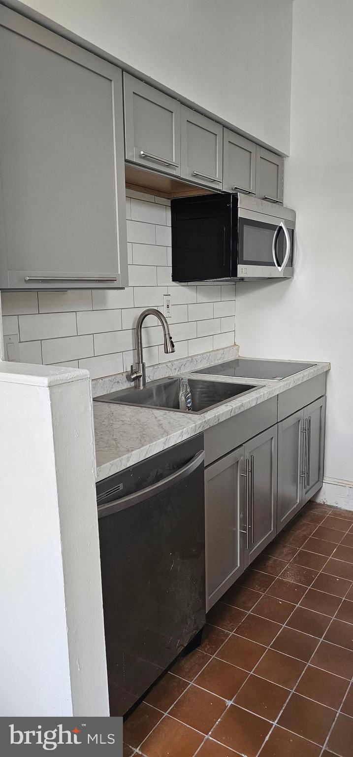 3618 Spring Garden Street Philadelphia, PA 19104 - Photo 9 of 41 a kitchen with stainless steel appliances a sink and a microwave