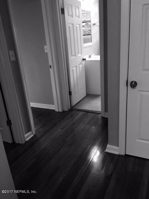 1344 Harbor Oaks Road Jacksonville, FL 32207 - Photo 14 of 40 a view of a hallway with wooden floor and a cabinet