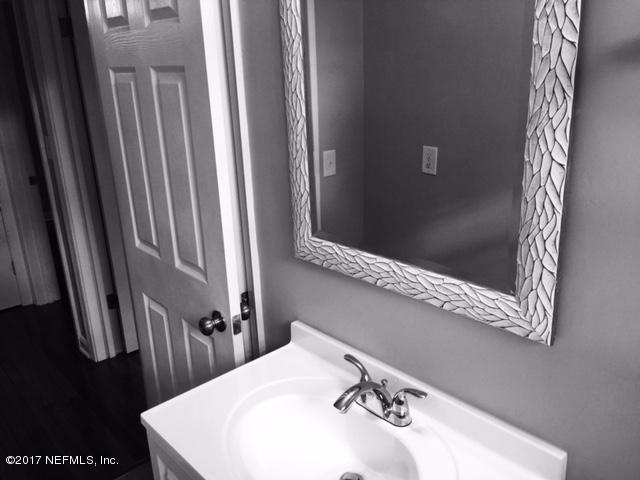 1344 Harbor Oaks Road Jacksonville, FL 32207 - Photo 18 of 40 a bathroom with a sink a mirror and a shower