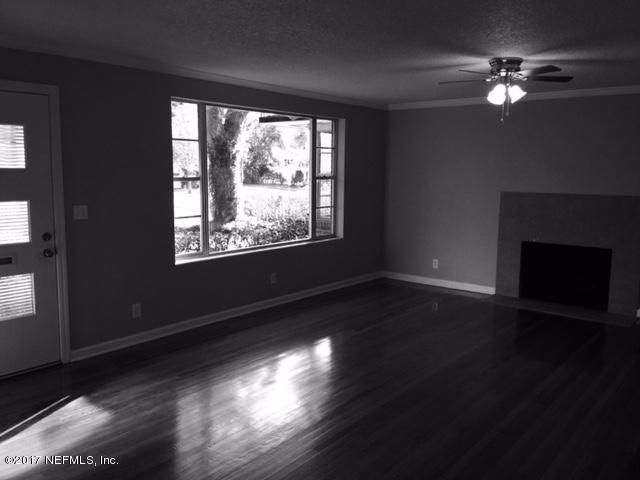 1344 Harbor Oaks Road Jacksonville, FL 32207 - Photo 3 of 40 a view of an empty room with wooden floor and a window