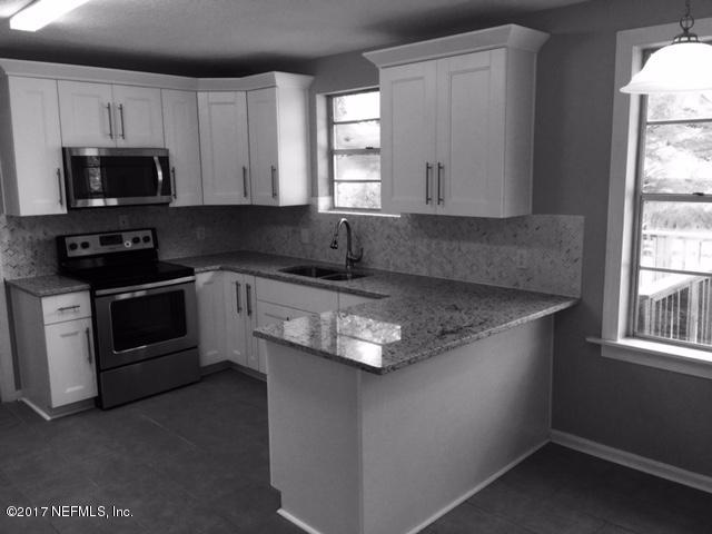 1344 Harbor Oaks Road Jacksonville, FL 32207 - Photo 6 of 40 a kitchen with stainless steel appliances granite countertop a sink stove and microwave