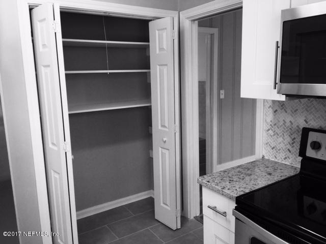 1344 Harbor Oaks Road Jacksonville, FL 32207 - Photo 10 of 40 a view of kitchen island with stainless steel appliances wooden floor washer and dryer