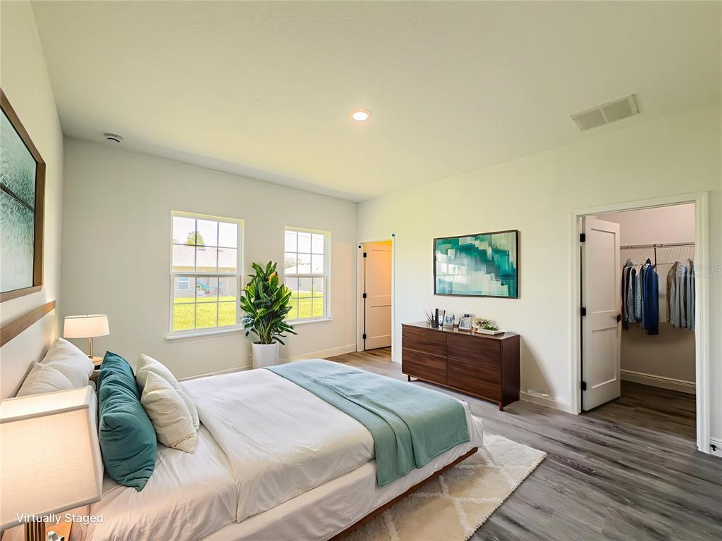 14245 Southwest 28th Court Ocala, FL 34473 - Photo 25 of 85 a spacious bedroom with a bed and wooden floor