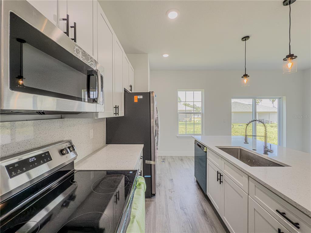 14245 Southwest 28th Court Ocala, FL 34473 - Photo 34 of 85 a kitchen with a sink stove and microwave